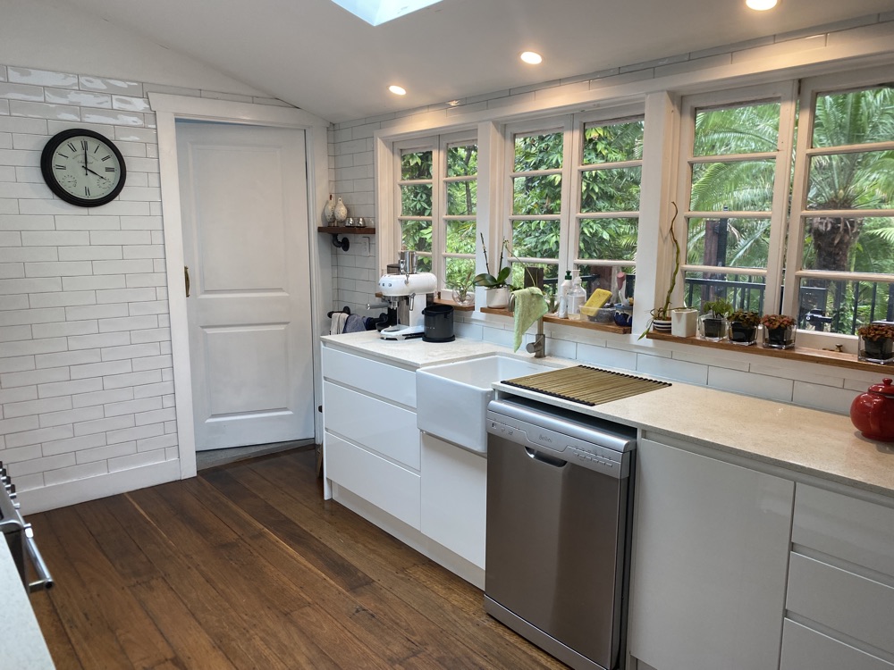 Kitchen with a farmhouse sink and rainforest views from every window